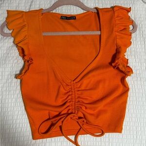 Orange ruffle top